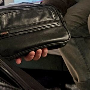 TUMI Black Leather Clutch Used, No accessories.
